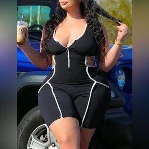 “Body Romper” in black with white contrast lines.